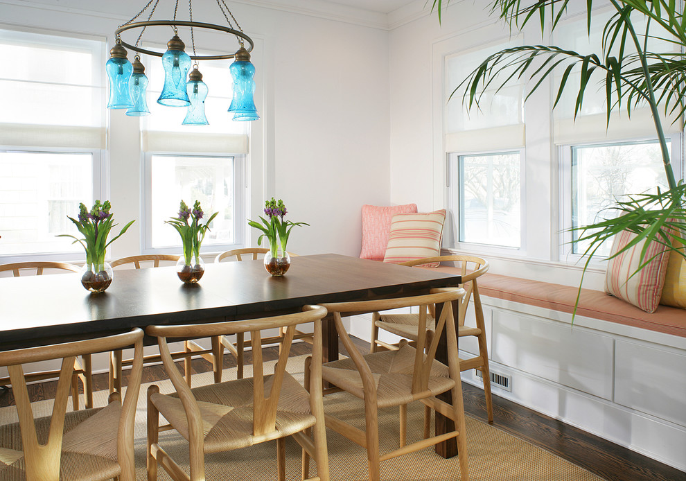 Inspiration for a small coastal dark wood floor and brown floor enclosed dining room remodel in Newark with white walls