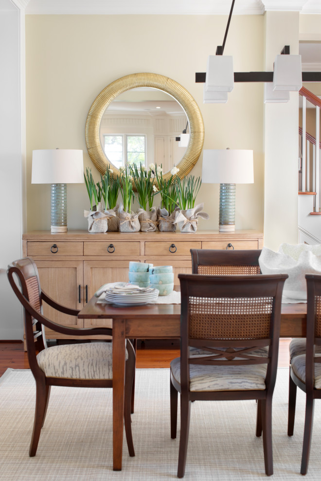 Photo of a beach style dining room in Charleston with beige walls, dark hardwood flooring and brown floors.