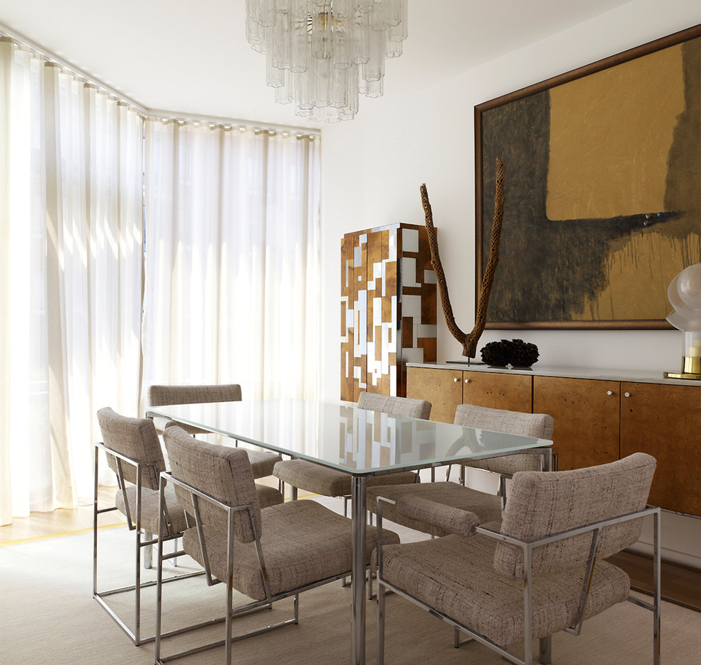 This is an example of a medium sized contemporary open plan dining room in New York with white walls and light hardwood flooring.