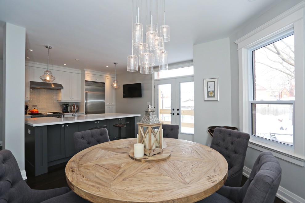 Example of a mid-sized transitional dark wood floor and brown floor kitchen/dining room combo design in Toronto with gray walls and no fireplace