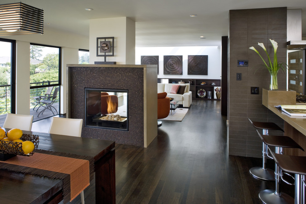 Contemporary open plan dining room in San Francisco with a tiled fireplace surround and a two-sided fireplace.