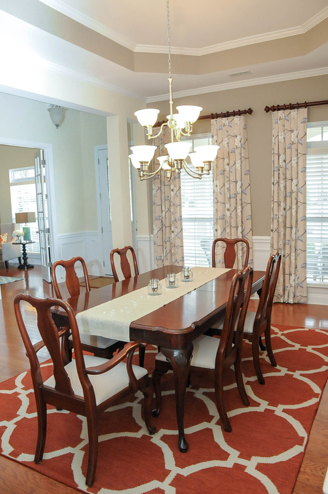 Mid-sized elegant medium tone wood floor dining room photo in Charlotte with beige walls