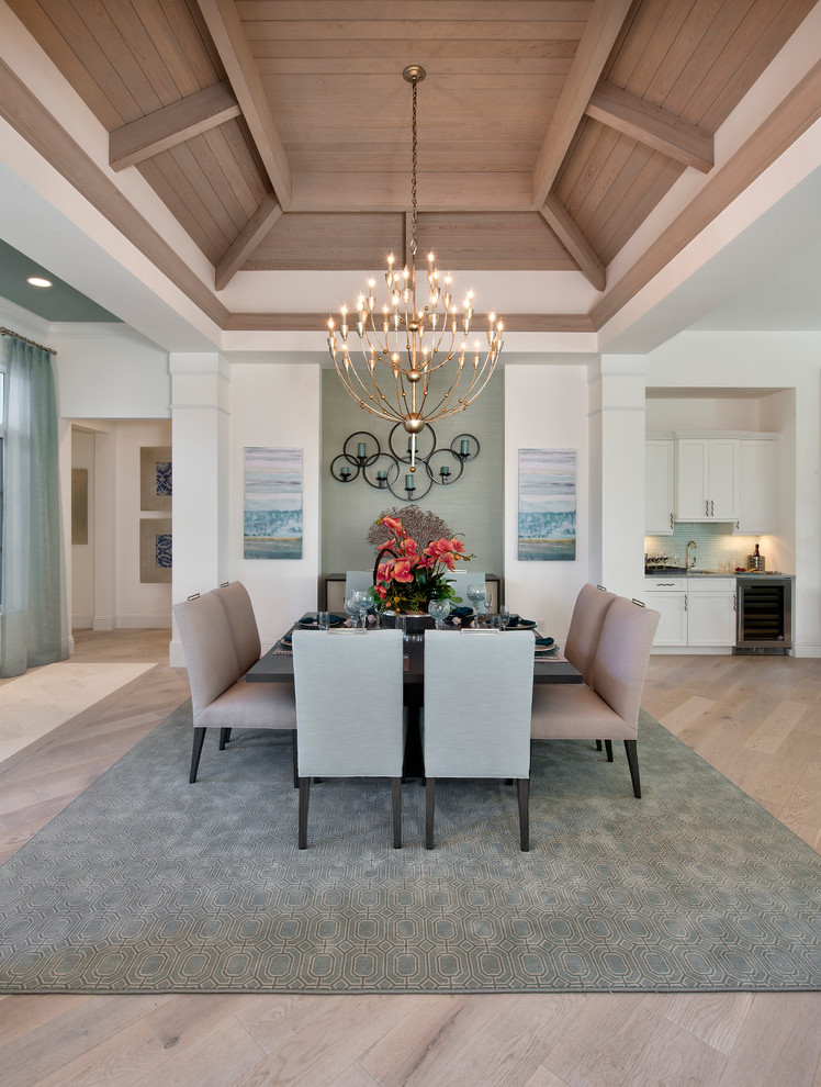 World-inspired dining room in Tampa with light hardwood flooring, no fireplace and white walls.