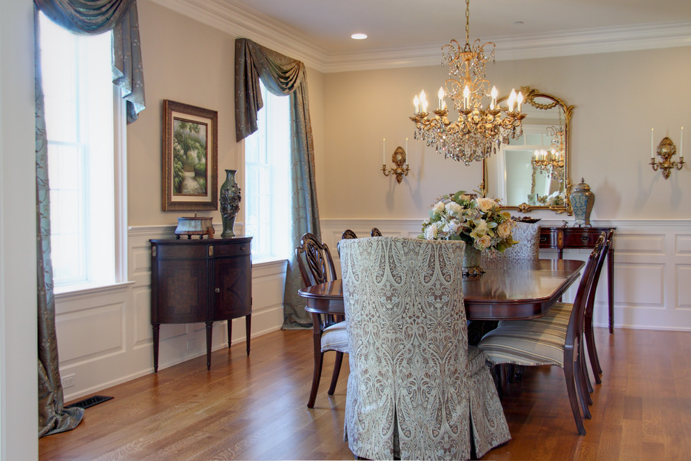 This is an example of a traditional dining room in Philadelphia with beige walls and medium hardwood flooring.