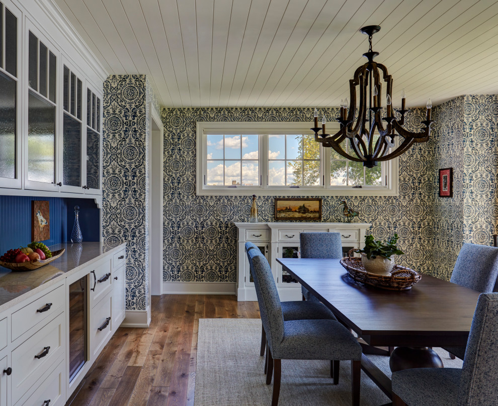 Foto di una sala da pranzo aperta verso il soggiorno american style di medie dimensioni con pareti blu, pavimento in legno massello medio, nessun camino e pavimento marrone