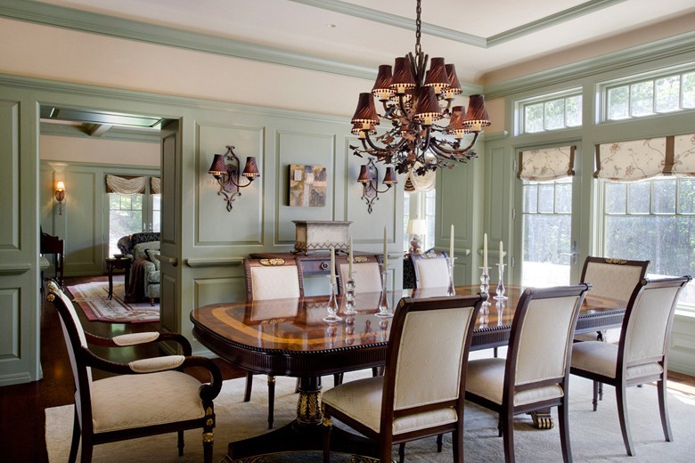 Example of a large classic dark wood floor enclosed dining room design in Boston with green walls and no fireplace