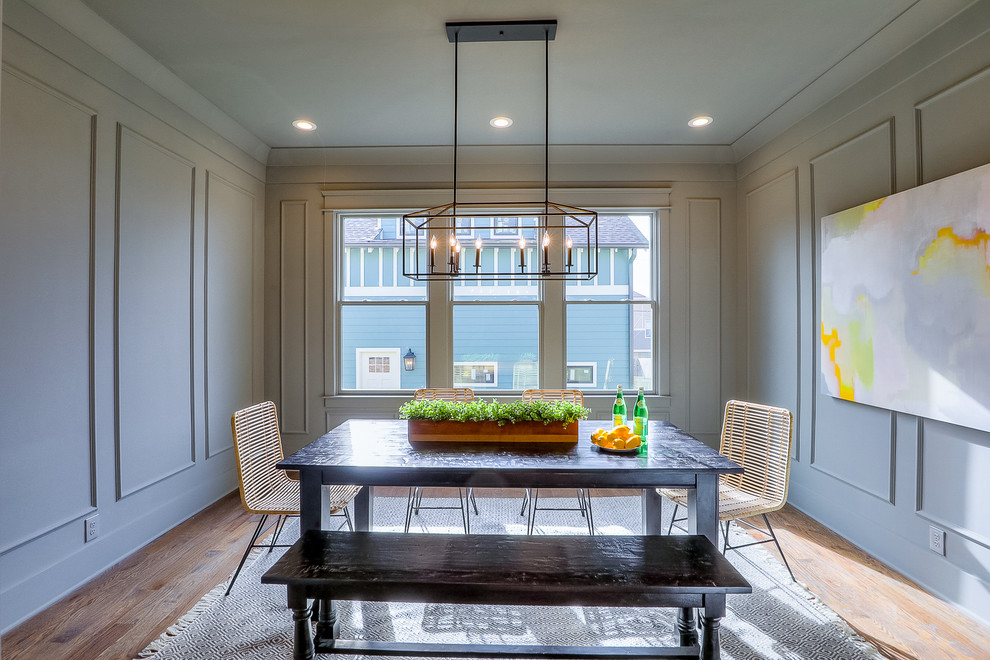 Photo of a small traditional enclosed dining room in Nashville with grey walls, medium hardwood flooring and brown floors.