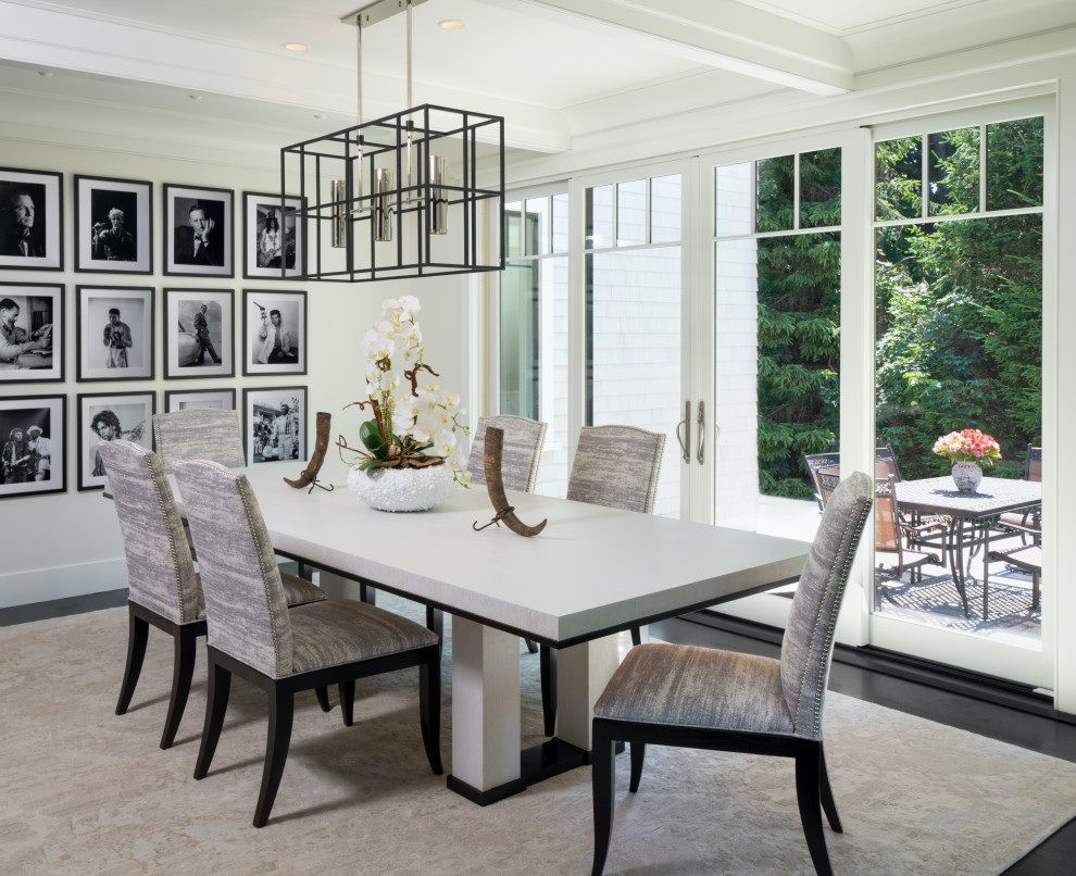 Inspiration for a traditional dining room in Boston with white walls, dark hardwood flooring and black floors.