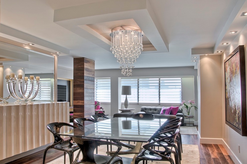 Photo of a contemporary open plan dining room in Montreal with feature lighting.