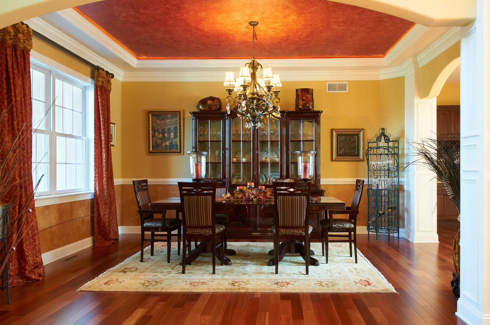 Design ideas for a large traditional dining room in Other with yellow walls, medium hardwood flooring and no fireplace.