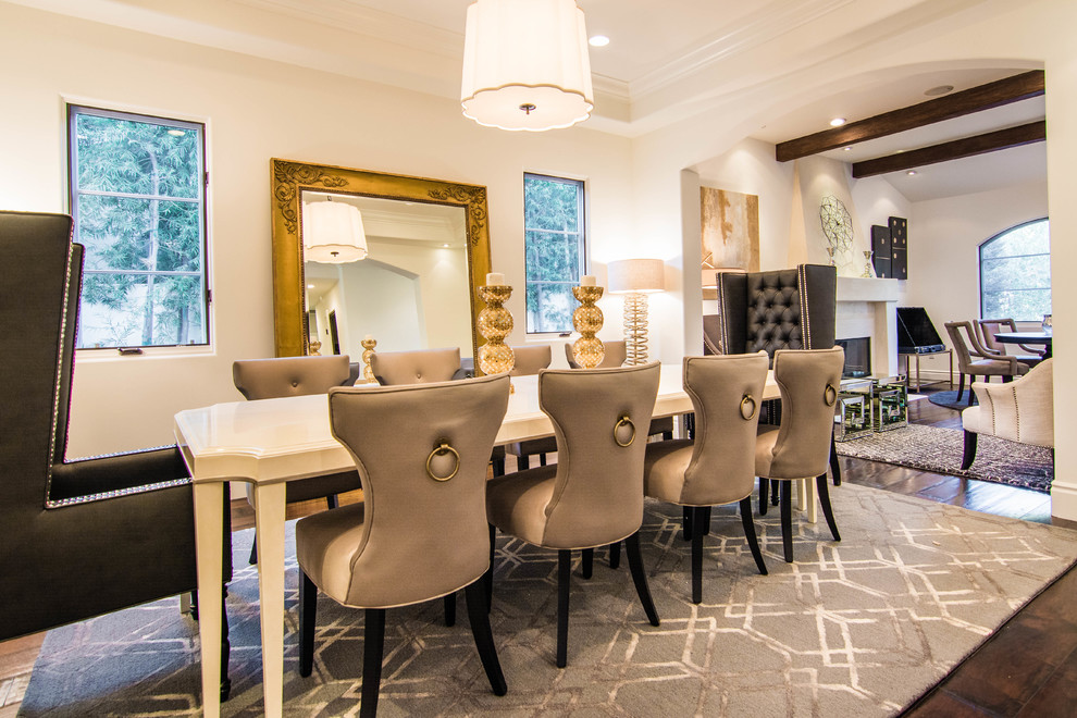 Example of a large transitional dark wood floor and brown floor great room design in Los Angeles with white walls, a standard fireplace and a concrete fireplace