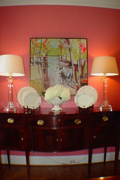 Elegant medium tone wood floor enclosed dining room photo in Charlotte with pink walls
