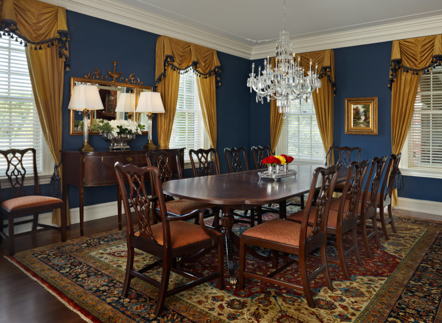 This is an example of a large traditional enclosed dining room in Other with blue walls, dark hardwood flooring, no fireplace and brown floors.