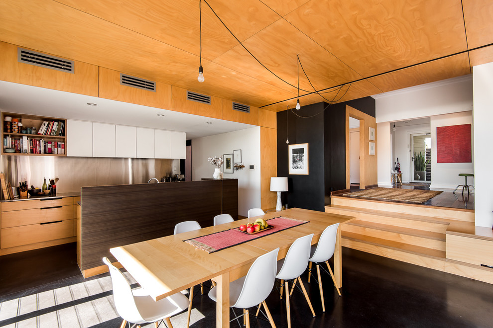 Ispirazione per una sala da pranzo aperta verso la cucina nordica di medie dimensioni con pareti bianche e pavimento in cemento