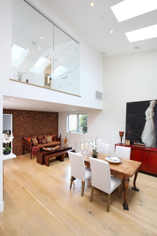 This is an example of a contemporary open plan dining room in Orange County.