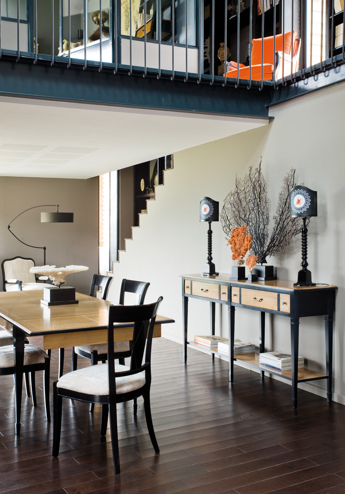 Medium sized traditional dining room in New York with grey walls and dark hardwood flooring.