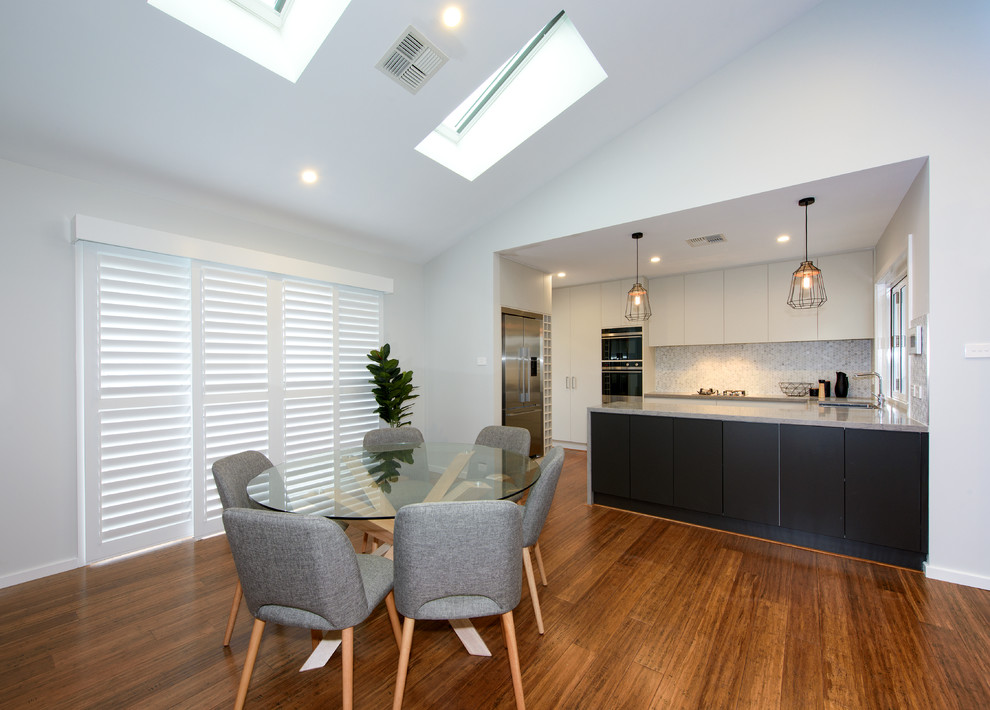 This is an example of a small contemporary open plan dining room in Central Coast with grey walls, bamboo flooring, no fireplace and brown floors.