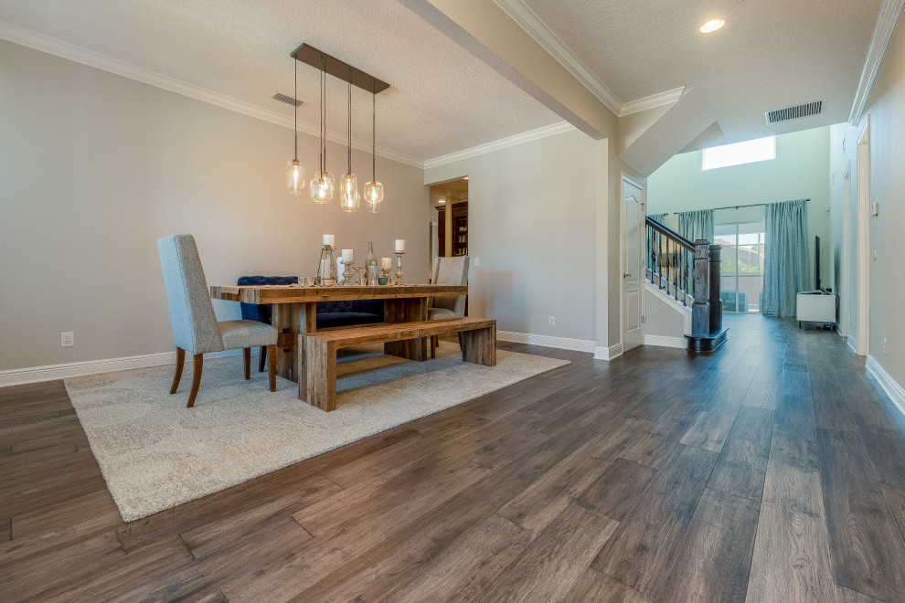 Photo of a large contemporary open plan dining room in Orlando with grey walls, medium hardwood flooring, no fireplace and grey floors.