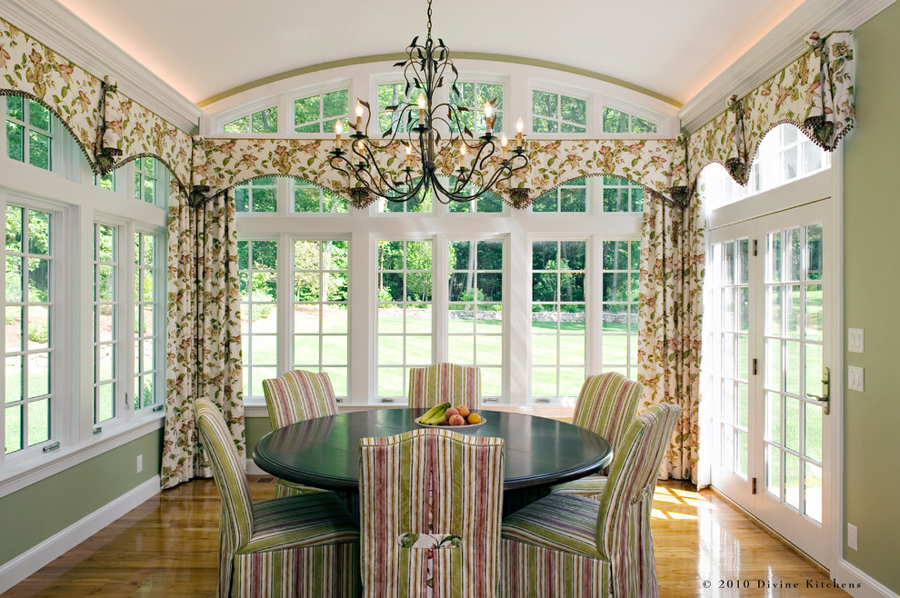 Elegant medium tone wood floor dining room photo in Boston with green walls