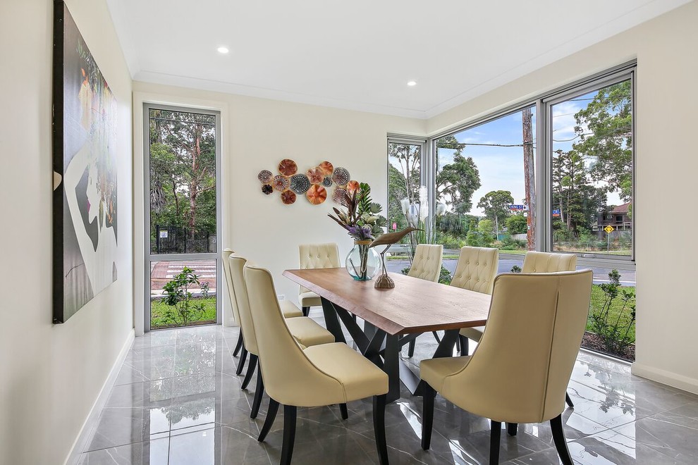Photo of a medium sized contemporary enclosed dining room in Sydney with beige walls, marble flooring and grey floors.