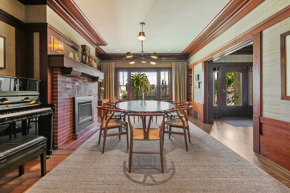 Enclosed dining room - large traditional medium tone wood floor enclosed dining room idea in San Francisco with a standard fireplace and a brick fireplace