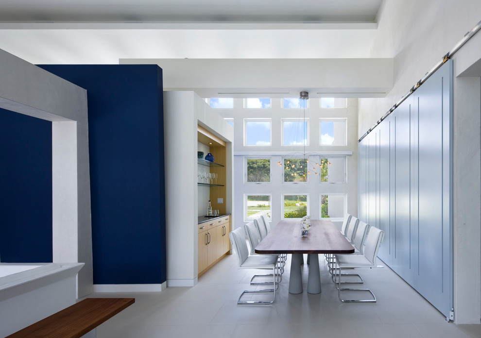 Photo of a contemporary dining room in Miami with white walls and porcelain flooring.