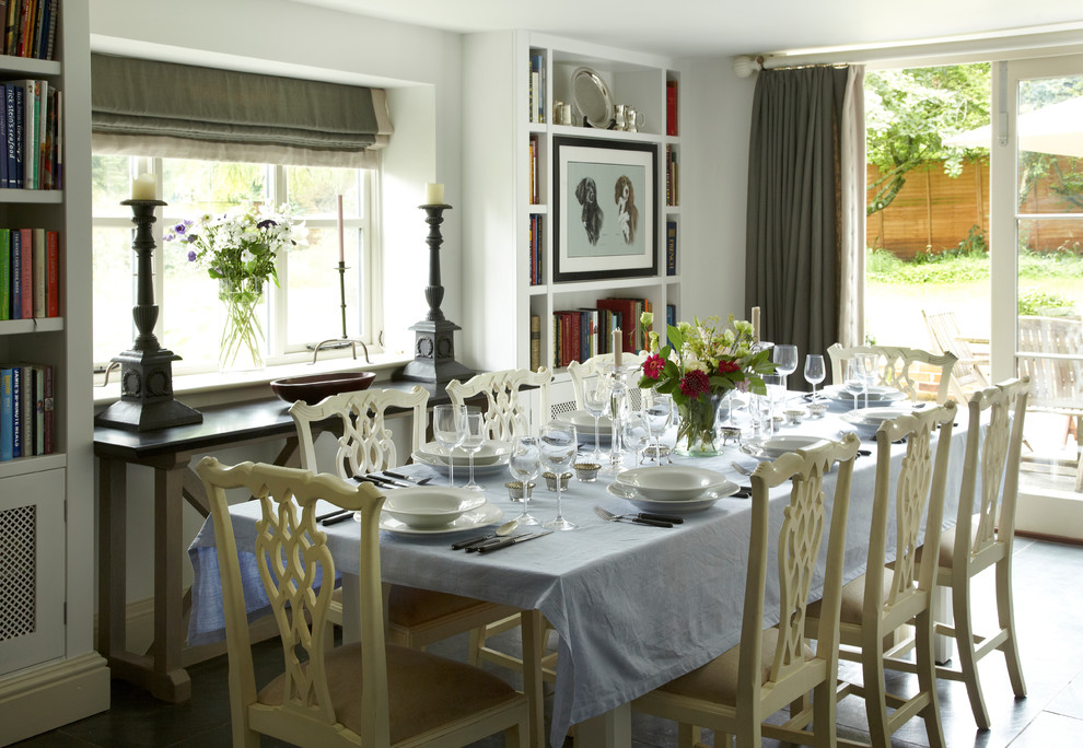 Foto di una sala da pranzo aperta verso la cucina country con pareti bianche e nessun camino