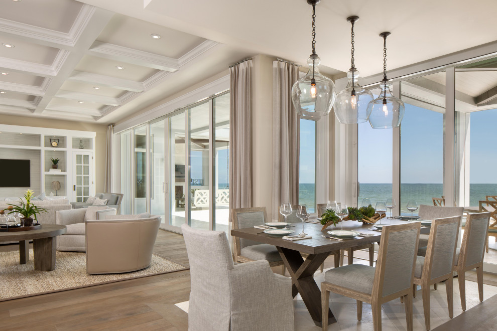 Inspiration for a medium sized coastal open plan dining room in Miami with beige walls, medium hardwood flooring, no fireplace and brown floors.