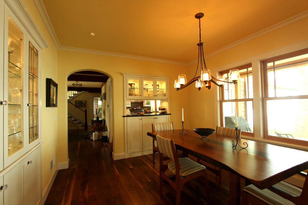 This is an example of a large rural enclosed dining room in Other with yellow walls and medium hardwood flooring.