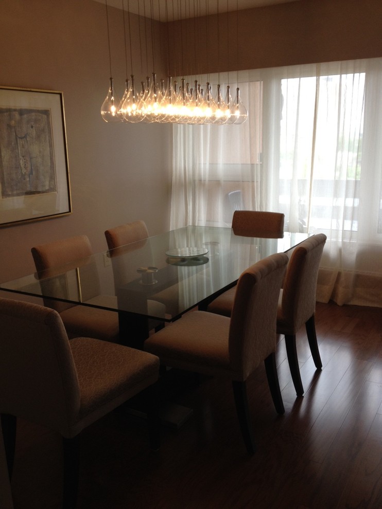 Photo of a small contemporary enclosed dining room in Ottawa with beige walls and medium hardwood flooring.