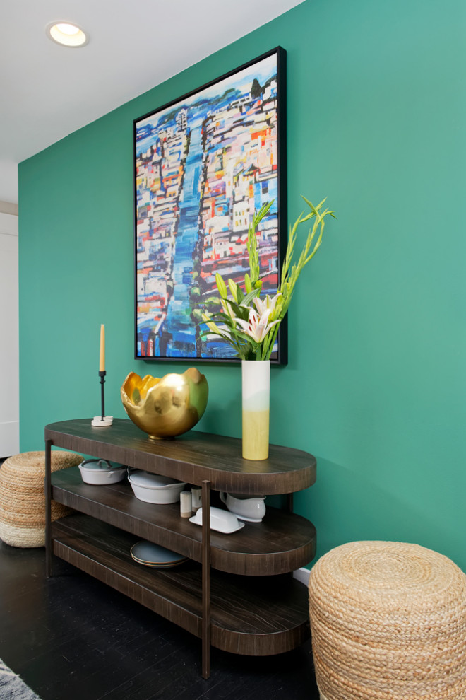 На фото: гостиная-столовая среднего размера в современном стиле с разноцветными стенами и черным полом без камина с