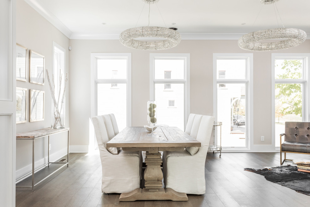 Immagine di una sala da pranzo aperta verso il soggiorno chic con pareti beige, parquet chiaro e pavimento beige