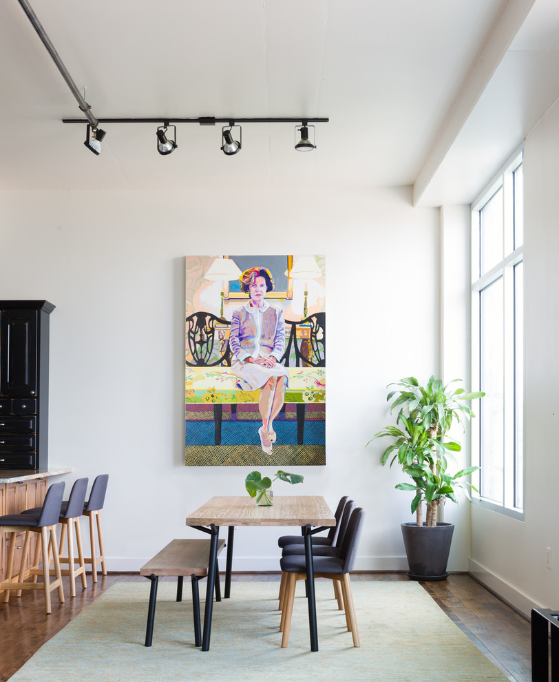 This is an example of a medium sized contemporary open plan dining room in Austin with white walls and medium hardwood flooring.