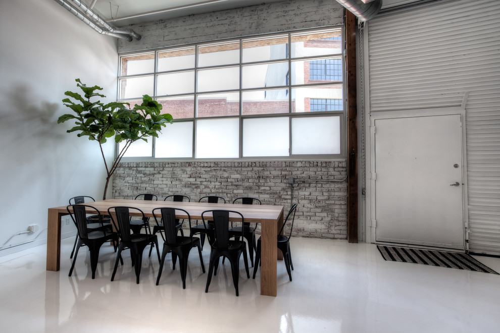Ispirazione per una grande sala da pranzo aperta verso il soggiorno minimal con pareti bianche, pavimento in cemento e pavimento bianco
