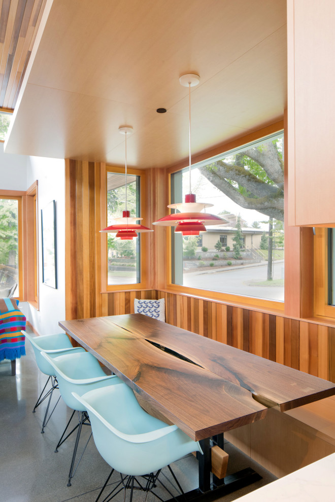 1960s concrete floor and gray floor dining room photo in Seattle with brown walls