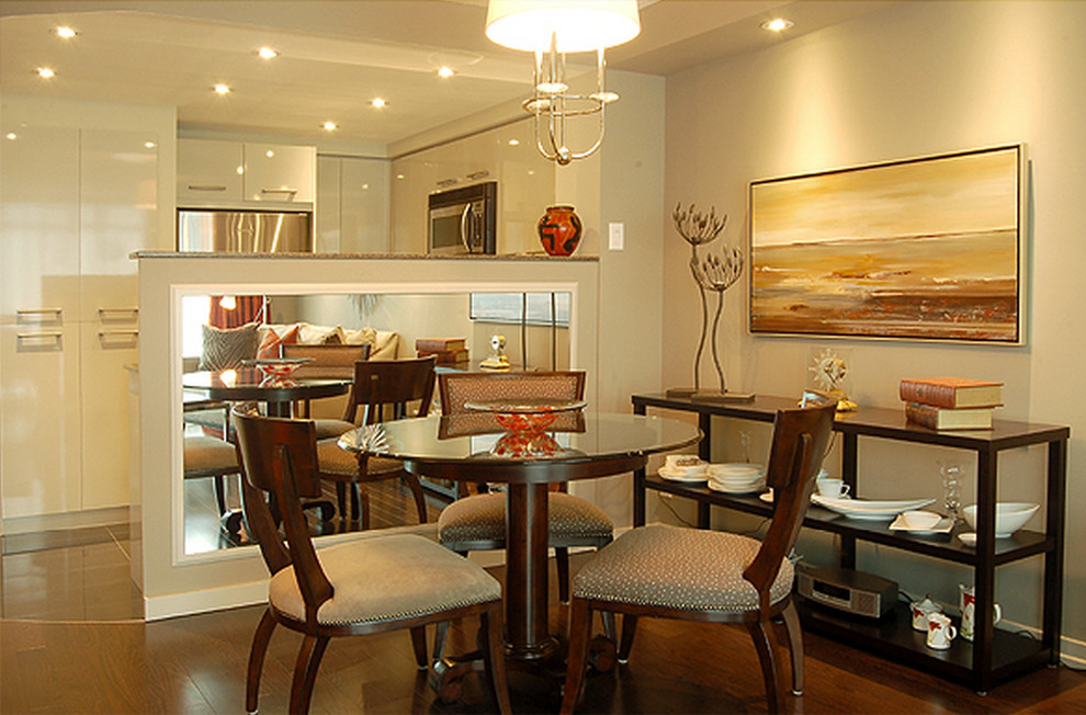 Photo of a small eclectic open plan dining room in Toronto with beige walls and dark hardwood flooring.