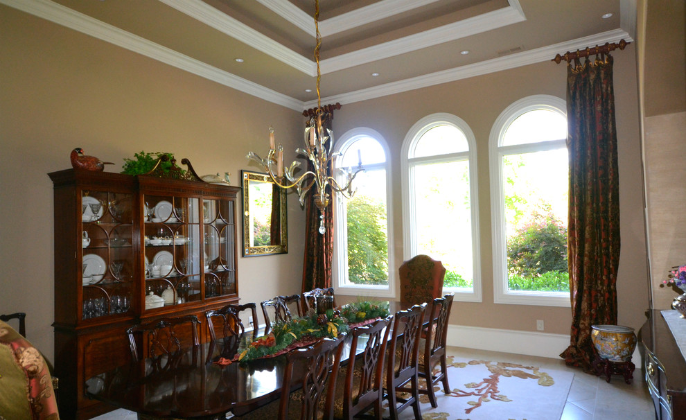 Example of a huge tuscan travertine floor enclosed dining room design in Raleigh with beige walls