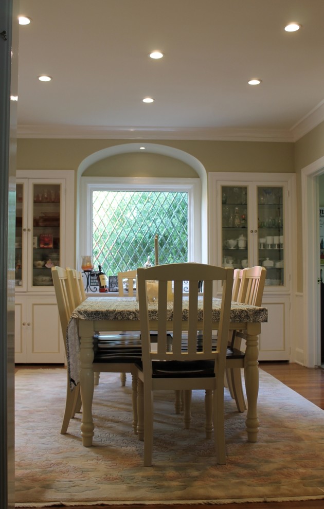 Example of a large transitional medium tone wood floor and brown floor enclosed dining room design in Los Angeles with green walls and no fireplace