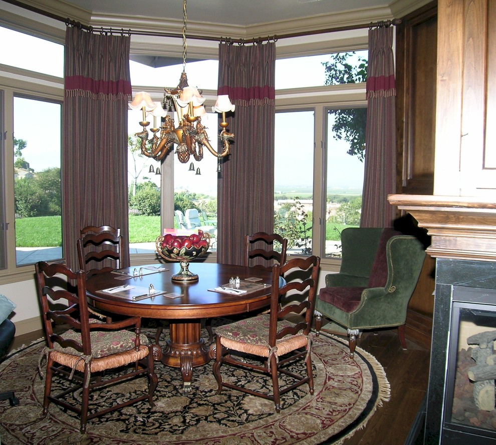 Example of a large classic light wood floor kitchen/dining room combo design in San Francisco with beige walls and a two-sided fireplace