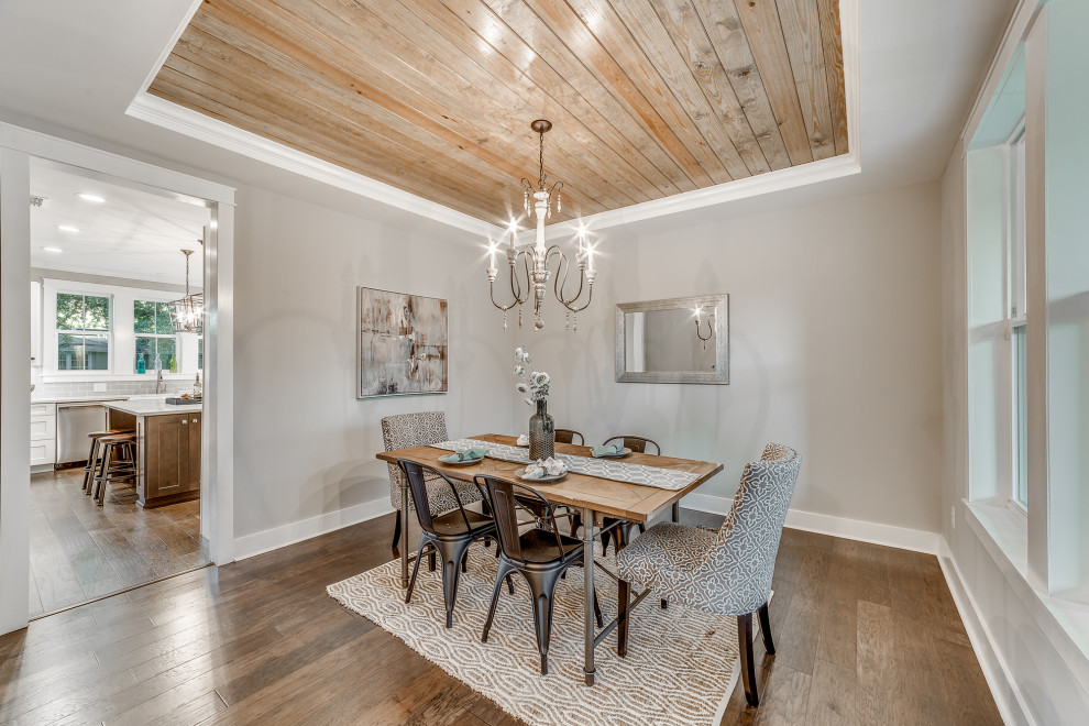 Enclosed dining room - mid-sized farmhouse medium tone wood floor and brown floor enclosed dining room idea in Jacksonville with gray walls