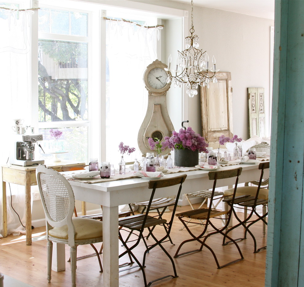 Photo of a romantic dining room in Other with medium hardwood flooring and beige walls.
