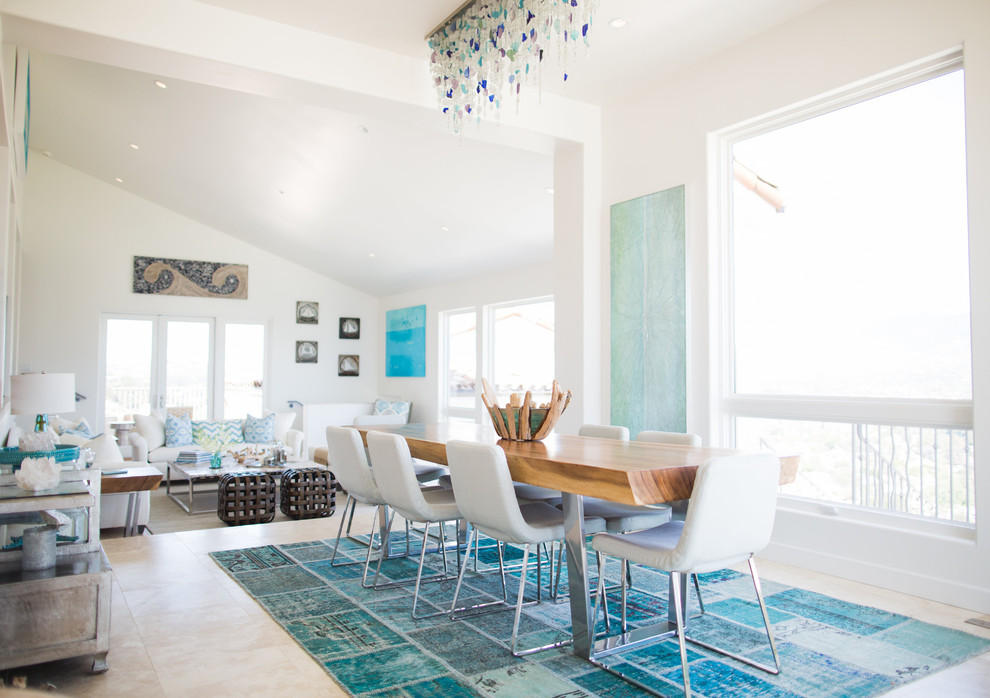 Photo of a coastal open plan dining room in Santa Barbara with white walls and feature lighting.
