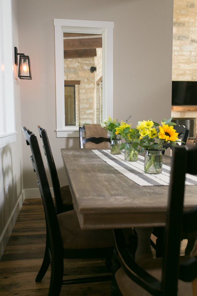 Farmhouse dining room in Austin with beige walls and medium hardwood flooring.