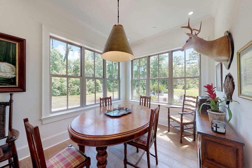 Mid-sized farmhouse light wood floor and brown floor enclosed dining room photo in Jacksonville with white walls and no fireplace