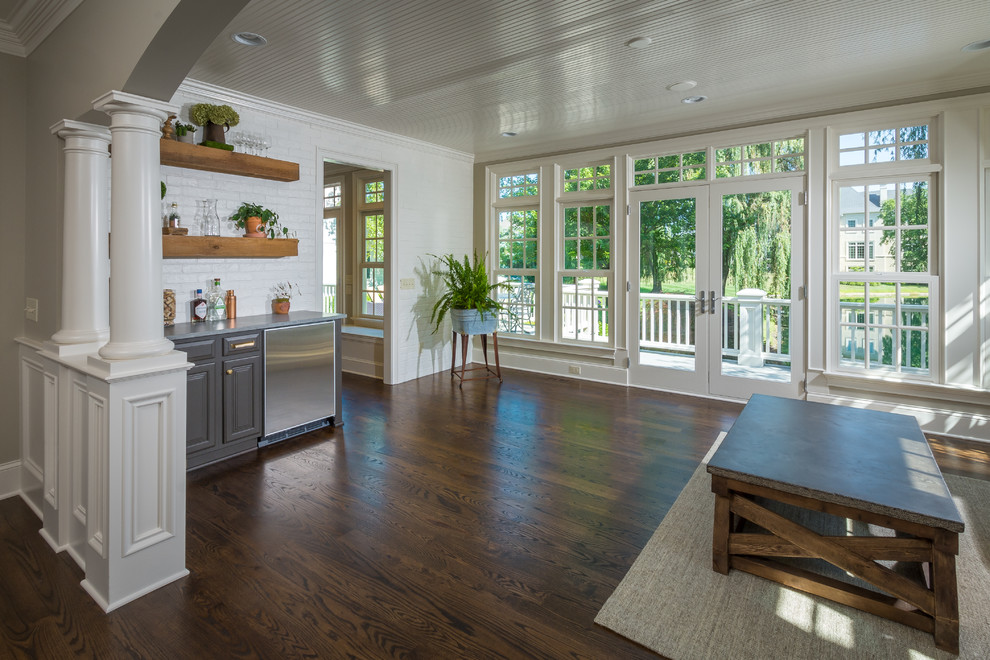 Example of a classic dark wood floor dining room design in Columbus with white walls