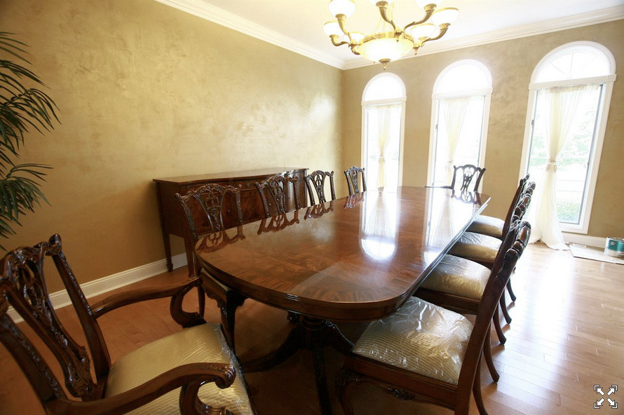 Large classic enclosed dining room in Bridgeport with metallic walls and light hardwood flooring.