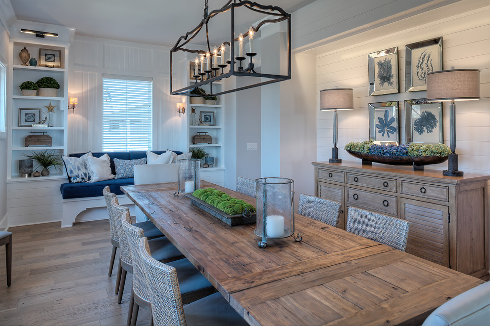 Design ideas for a nautical dining room in Other with white walls, medium hardwood flooring, brown floors and feature lighting.