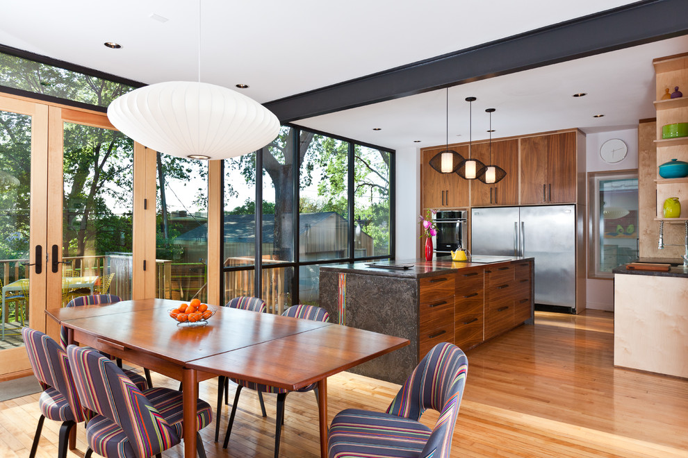 Photo of a contemporary kitchen/dining room in Kansas City with light hardwood flooring.