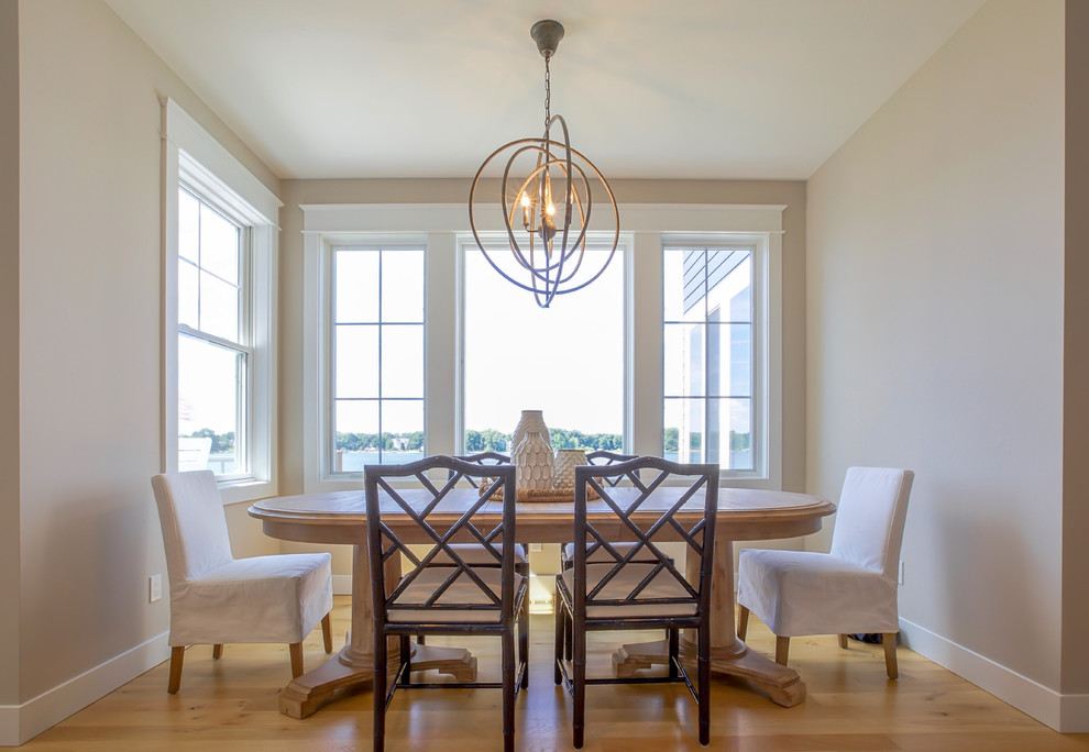 Photo of a medium sized contemporary open plan dining room in Grand Rapids with beige walls, light hardwood flooring and no fireplace.