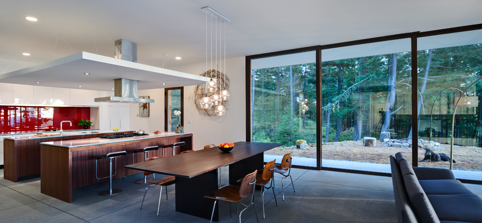 Example of a trendy concrete floor dining room design in Seattle with white walls and no fireplace